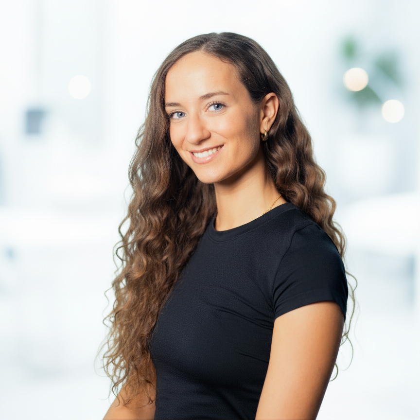 Bre Pittiglio, Registered Nurse Injector at Eterna Wellness, smiling in a medical spa setting, showcasing expertise in aesthetic services like Botox and IV therapy.